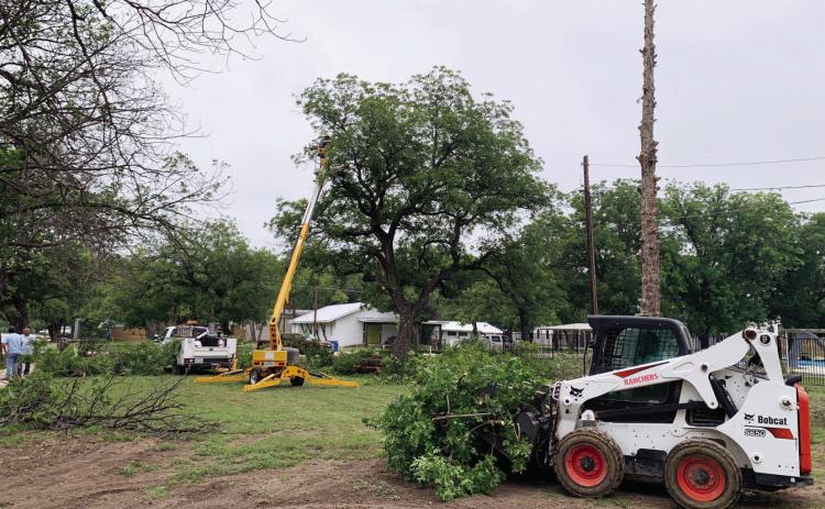 IMPROVEMENTS CONTINUE at county-owned American Legion Park. Both county and city crews and equipment worked to remove one unhealthy tree and trim others in preparation for installation of the Menard Youth Initiative funded playground area. The park improvements are part of an ongoing effort backed primarily by a LCRA grant. TMN photo.
