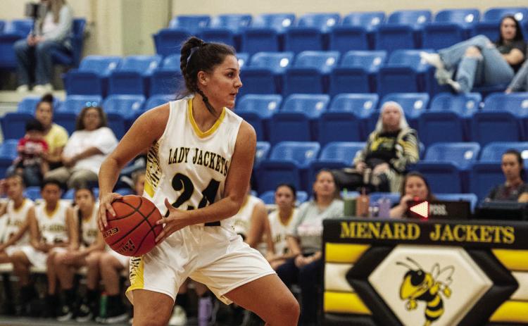 SENIOR Lady Jacket Makinley Kothmann looks to set up a play when Menard hosted Iraan last week.