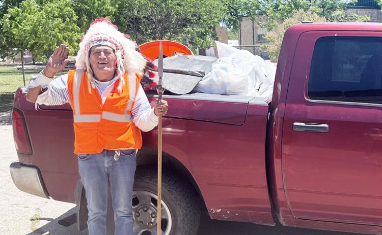 HEADDRESS AND SAFETY VEST secured, Chief Broken Eagle (Ray Hernandez) spent Earth Day picking up trash along his Adopt a Highway section of US 83 S. Chief collected a full pickup bed full of refuse off the side of the road. TMN photo.