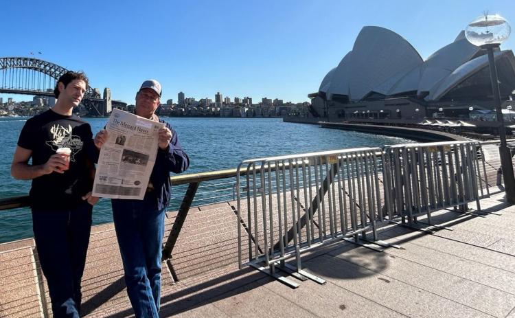 John Davis (r), the philanthropic owner of The Menard Station and Pecan Spring Ranch, and son Samuel Davis (l) kept up with news in Menard via The Menard News on a recent trip to Sydney, Australia. Courtesy Photo.