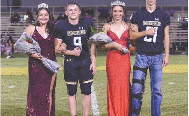 THIS IS HOW WE DO IT- Freshly-crowned Band Sweetheart Tatum Ruiz, far left, was escorted by Hunter Whitaker on Friday at Menard's Homecoming. Football Queen Hailey Ruiz and her escort Colby Powell joined them midfield following the halftime crowning ceremony. You can read more about the Sweetheart, Queen, and the entire court on page 10. Nora Davis, Photo.
