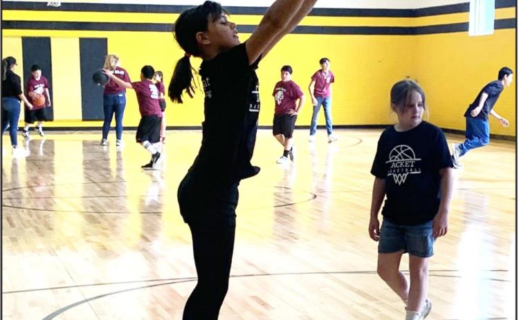 RIGHT-Sara Ogden warms up before the Menard girls grades 3/4 team takes on Paint Rock. Teammate Kayla Trimble looks on.