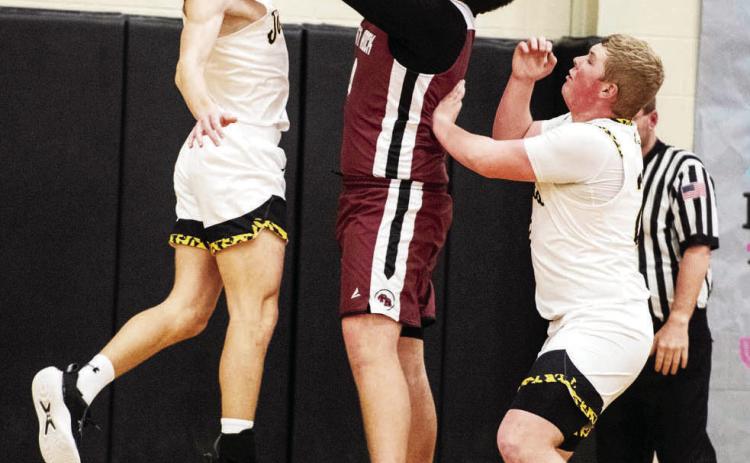 Menard's Wyatt Terrell, left, joins teammate Tate Wagner to shut down a Paint Rock shooter during the Jackets' win over Paint Rock last week. See page 7. Sandy Kothmann, photo.