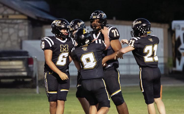 ATTA BOY! JV football teammates Sam Mayfield (6), Mack Davis (8), and Kade Bannowsky (21) congratulate Julian Wat - son (71) on his first career touchdown, scored against Paint Rock at home last Thursday evening. The JV Jackets shut out the Paint Rock Indians 47-0 last week. The varsity (5-0) continued the trend on Friday with their 62-0 win, and the Junior Jackets also got the home win, 48-12. See additional football photos on our Jacket Backer feature on page 8. Photo by Nora Davis.
