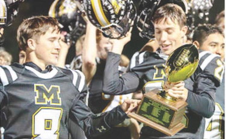POW POW- Seniors Logan Powell and Colby Powell check out the bi-district golden ball the Yellowjackets secured last week with a 54-7 win over Benavides. The Powell brothers are the only senior Jackets this year, and they will have their work cut out for them leading the team against Gordon in the area playoff on Thursday. Nora Davis, photo.