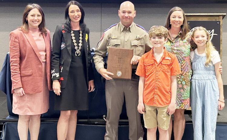 TROOPER RECOGNITION- Sergeant Lee Meadow, center, accepts his recognition from the Border Prosecution Unit (BPU) for his years-long contributions to Operation Lone Star. Meadow is stationed in Boerne. The family lives in Junction, and attend school/teach in Menard. Pictured left to right is Havana Schmidt, 452nd BPU Assistant DA; Tonya Spaeth Ahlschwede, 452nd DA and Chair of the BPU; Sergeant Lee Meadow, Jackson Meadow, Myghan Meadow, Saydee Meadow. Courtesy photo.