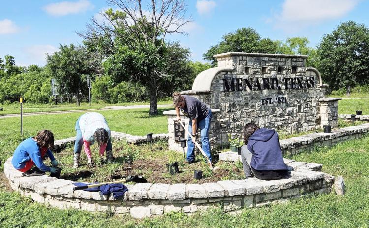 TEAM WORK MAKES THE DREAM WORK for Beautification of Menard projects. Above, volunteers in May work to refresh the landscaping at the city sign just north of the river at the 190/83 intersection. Courtesy photo.