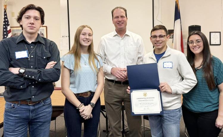 U.S. Congressman August Pfluger was in Menard for a town hall forum last week. Pfluger took the time to present the drum majors and band director a certificate of Congressional Recognition for the group’s second state championship earned in the fall. Pictured are drum majors Aydan Wilson and Cozette Halley, Rep. Plfluger, drum major Kevin Johnson, Ms. Cook, director.