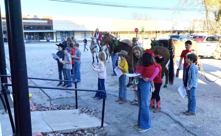 THE MENARD 4-H HORSE CLUB rounded up their steeds and joined other 4-H members in serenading the residents and staff at Menard Manor before Christmas last week. Lisa Brown, photo.