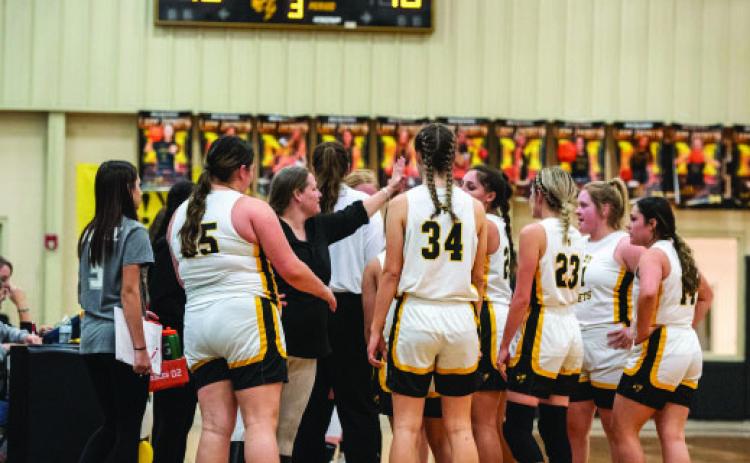 Coach Saller and Coach Bell coach the Lady J’s during the Panther Creek Game under the ‘Jackets 42 to Panthers 16 score board.