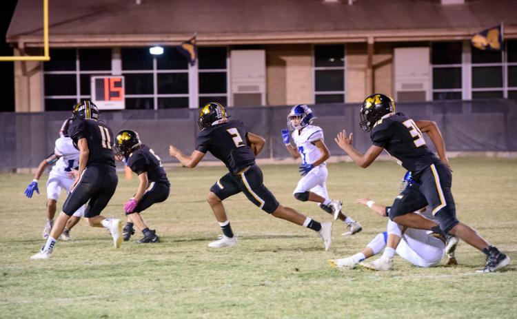 Senior Jay Guerrero (2) carries the ball, with the help of blockers Terrell (11), Rayburn (5) and Stanislawski (30).