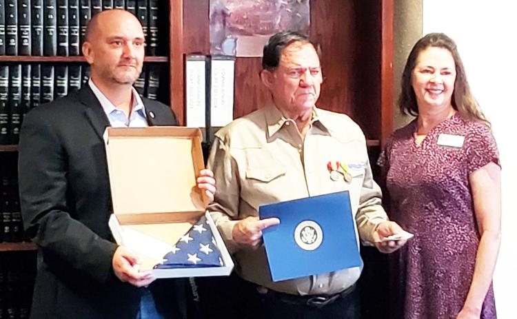 IT'S ABOUT TIME- Menard County Judge Brandon Corbin, left, presented James Ray Baker with his military honors earned in Vietnam. Because of a paperwork error, Baker had been listed as dishonorably discharged from the U.S. Army. The incorrect status was finally righted thanks to Congressman Pfluger's office and the local veterans coalition. Baker is pictured center. Carol Cunningham, right, was present from Pfluger's camp. Menard County photo.