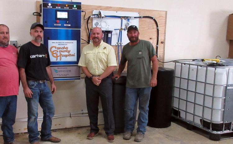 Menard County Emergency Coordinator Jeff Whitson, installer Jessy Haney, High School Principal Jacob Hand, and MISD maintenance supervisor Beau Tipton with the new anolyte generaor provide by Concho County Hospital. TMN photo.