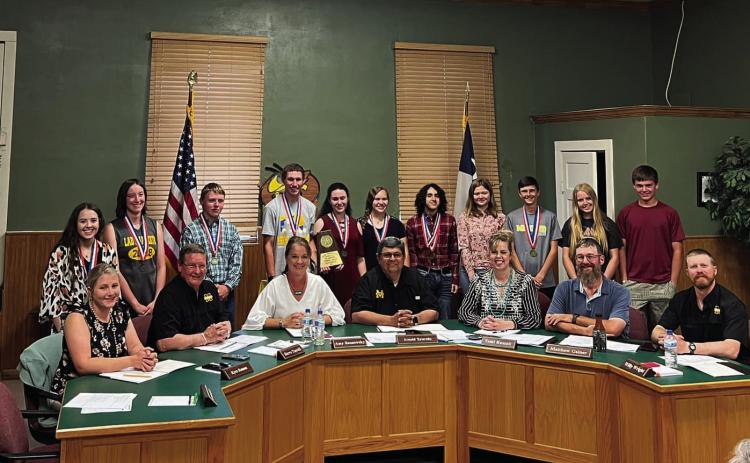 School board members seated l to r: Kyra Ramon, Steve Terrell, Amy Bannowsky, Superintendant of Schools; Arnold Saucedo, Tami Russell, Matt Gainer, and Willy Wright. Students standing l to r: Aminy Anderson, Katherine Russell, Mathis Martin, Wyatt Terrell, Katelyn Maher, Kasey McCullom, James Hernandez, Khloe McCaffery, Roy Brown, Addy Bannowsky, Cado Bannowsky. See results on page 6. The Bannowsky siblings competed in the State CX Debate earlier in the year. Courtesy photo.