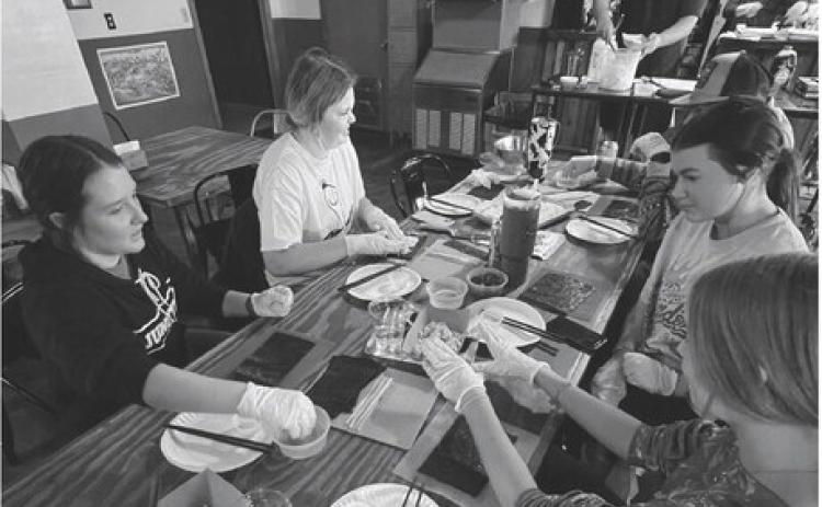 Junction High School assemble California sushi rolls with instruction from Luke and Sarah Johanson, Summerland Public House owners shown in the background. All of the ingredients used can be purchased locally at Lowe’s with the exception of the seaweed paper. Courtesy Photo.