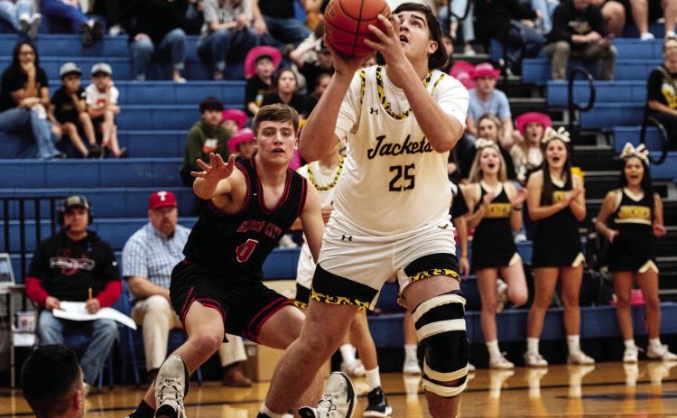Ayden Ramon #25 bests the defense to shoot for 2 in Monday’s playoff loss against Garden City. Senior Kade Rayburn #4 stiff arms the