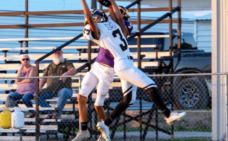 Menard's Jayden Payton snags a pass away from a Mullin Bulldog during their game last Thursday. The Jackets came out on top 52-7. Nora Davis, photo.