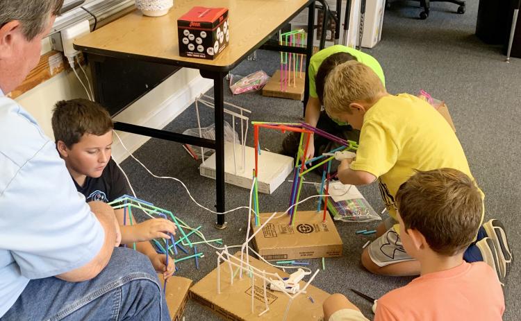 STEM FUN- Menard Elementary 4th and 5th graders have spent the week completing a special STEM (Science, Technology, Engineering and Math) project in their science class with Ms. Wynne Simon. The students were tasked with building roller coasters for a ping pong ball using drinking straws. Parents and guardians were encouraged to attend a class to encourage and assist their student. TMN photo.