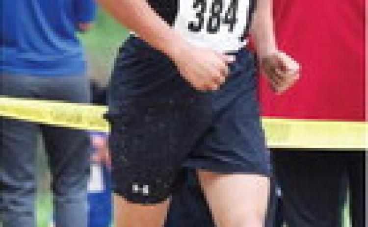 BELOW LEFT- Floyd Teague fights to the finish line at the Mertzon meet.