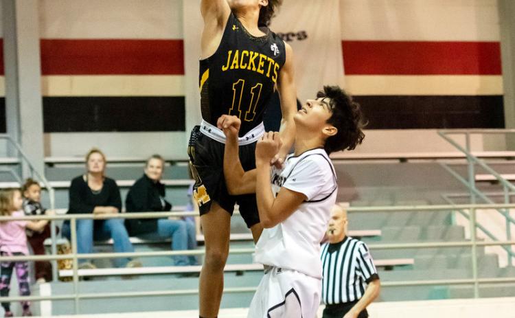 RIGHT- Menard's Marlee Salas goes above and beyond during the Jackets win over Panther Creek last week. Nora Davis, photo.