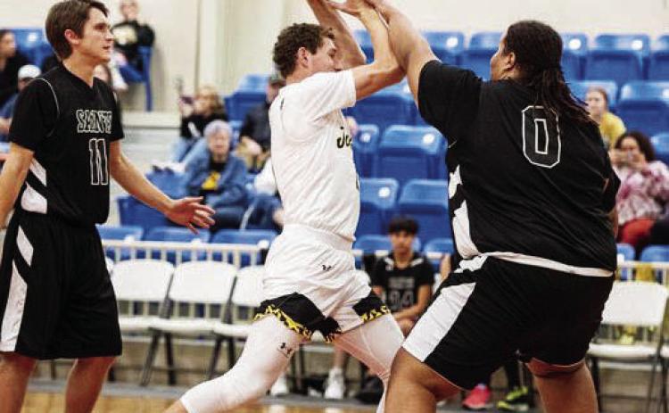 Senior Wyatt Terrell, center, tries to work through the San Angelo Saints defense.