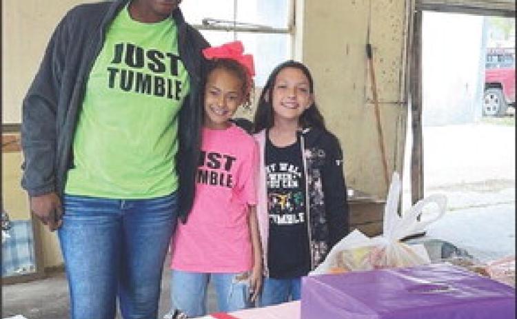 Tamara Hernandez, pictured left with two of her tumblers, Nayeli and Kelsey. Tamara, with family and friends, held a fish fry and bake sale on Good Friday. Funds will be put towards her new building location at the corner of Ellis and Mission St. in Menard.