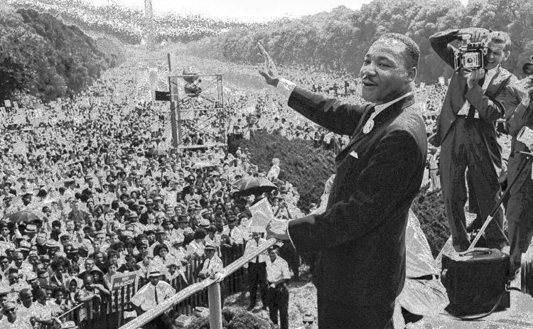 Martin Luther King Jr. waves to supporters from the steps of the Lincoln Memorial, Aug. 28, 1963, during the March on Washington. AP/Getty images.