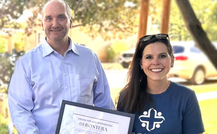 Frontera CEO Mikki Hand (R) presents Menard County Judge Brandon Corbin with an appreciation certificate for supporting Frontera Healthcare.