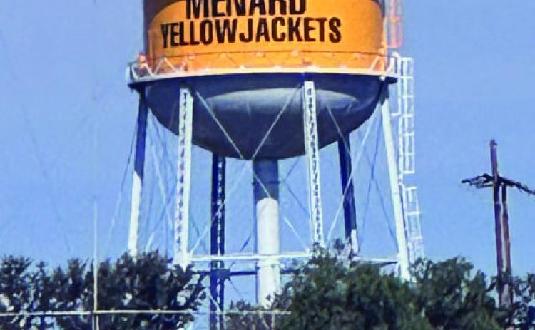 RIGHT- Look closely to see contracted crews continuing work atop the city's water tower. Upgrades are coming along, as evident by the new bold gold color and the addition of the town and mascot. Interestingly, the specifi c yellow/gold color used is Green Bay Gold, and the city was required to get permission from the Green Bay Packers in order to use the cheery hue. TMN photo.
