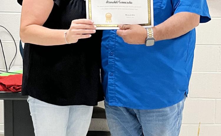 PTO President Valera Corbin presents Arnold Saucedo with the organization's Spotlight Award for his years of dedication to the youth of Menard. This recognition was previously known as the Lifetime Award. TMN photo.