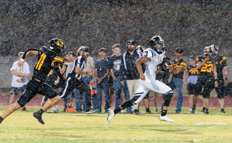 Yellowjacket Jayden Payton, #3, breaks through the Blanket defense for a touchdown during Friday's first -and rainy- football game of the season. After a couple of lightning delays the game was eventually called with 3:38 remaining in the second quarter, the score tied 14-14. Be sure to view this photo in color at menardnews.com. Nora Davis, photo.