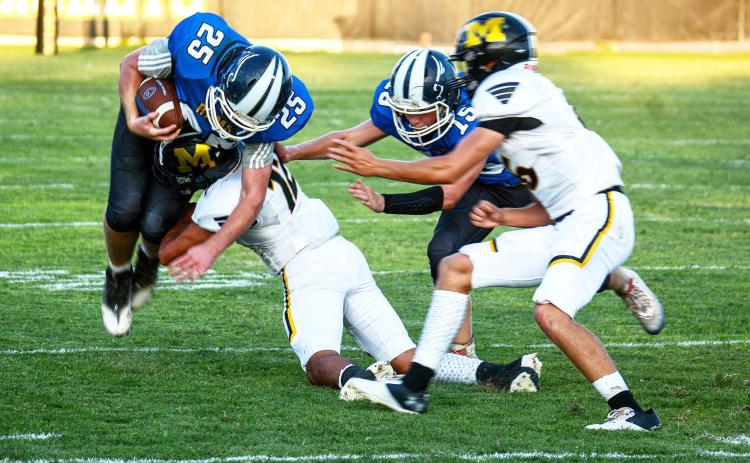 THE NEW ERA- Yellowjacket Jay Guerrero takes down a [San Marcos] Hill Country Christian ball carrier during Menard’s routing of the Rams last Saturday night. Teammate Joel Guerrero right, gets in on the play. The Jackets were victorious 47-2. Sandy Kothmann, photo.