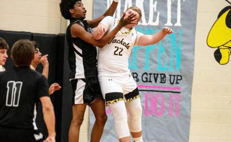 YELLOWJACKET Tate Wagner gets a faceful from a San Angelo Saint in Tuesday's boys basketball game. Menard fell to the San Angelo Saints 25-54. The Saints are part of the San Angelo Homeschool Sports Assc. See full schedules and additional photos on pages 8 and 9. Sandy Kothmann, photo.