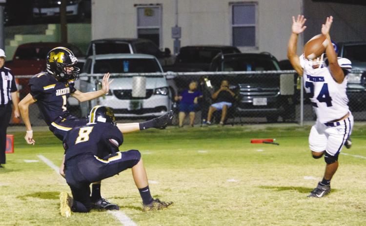 PERFECTION- Senior Roy Brown executes one of his nine successful PATs during Menard’s 72-13 blowout Homecoming win against Nueces Canyon Friday night. Fellow Yellowjacket Logan Powell (8) holding the ball. Nora Davis, photo.