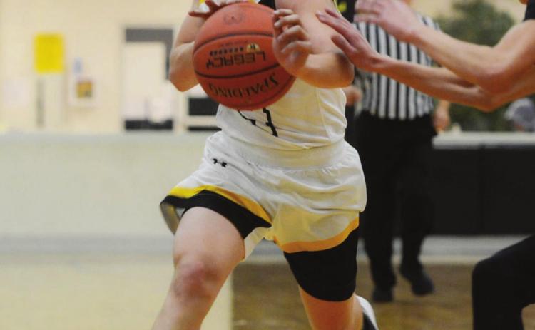 LEFT- Menard’s Kade Rayburn works the ball down the court in the Jackets’ win against Paint Rock last Friday. Sandy Kothmann, photo.