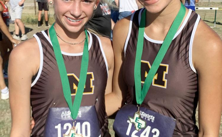 STARTING THE SEASON ON TOP- Freshman Taytum Chambless, left, and sophomore Danni Ruiz both medaled at the first cross country meet in Eldorado last week. Danni, who placed eighth in last year's state meet, won the Eldorado contest. Chambless battled until the end to claim third. Saller photo.