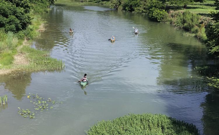 San Saba River kayakers paddle east near the high bridge last spring. TMN file photo.
